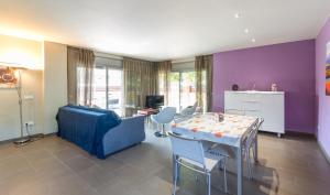 a living room with a table and a blue couch at Villa Alegria in L'Escala