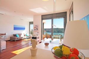 a living room with a couch and a table at Villa Barbara in L'Escala