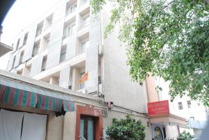 a large white building with a sign in front of it at Hotel Tourist Deluxe in New Delhi