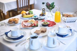 una mesa blanca con platos de comida. en Casa Rural Sabariz, en Sabariz