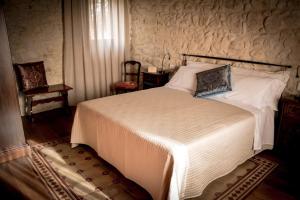 a bedroom with a large bed in a room at Agriturismo Valentina Cubi in Fumane