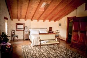 a bedroom with a bed and a table and chairs at Agriturismo Valentina Cubi in Fumane