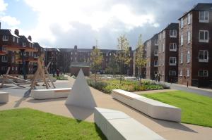 um parque com parque infantil e alguns edifícios em Maritime Apartments em Barrow in Furness