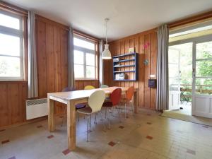 a dining room with a wooden table and chairs at Spacious Holiday Home with Swimming Pool in Cuzy in Cuzy
