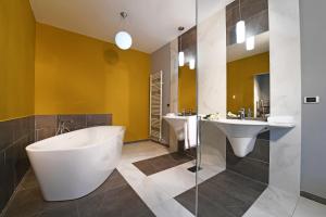 a bathroom with two sinks and a tub and two sinks at Panoramic Villa Garassino - country rooms and fine restaurant in Treiso