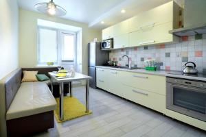 a kitchen with a couch and a table in it at PaulMarie Apartments on Chigrinova in Mogilev