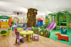 a childrens playroom with a play area with a table and chairs at Majestic Palace in Malcesine