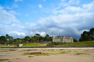 a house on top of a hill next to a beach at Golf View Hotel & Spa in Nairn