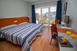 Postel nebo postele na pokoji v ubytování Hotel Azar + 37 fotografií