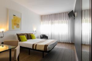 Postel nebo postele na pokoji v ubytování Hotel Umu
