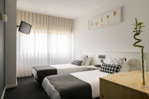 Postel nebo postele na pokoji v ubytování Hotel Umu