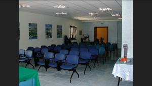 a conference room with blue chairs and a table at Masseria Frangiosa in Torrecuso