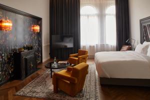 a bedroom with a bed and a tv and a table at Hotel Collect - Adults Only in Budapest