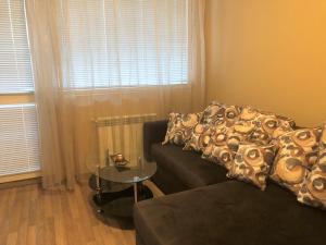 a living room with a couch and a glass table at Rakovski Apartment GN / FREE GARAGE in Sofia +14 photos
