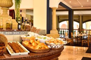 a table topped with lots of different types of food at Pestana Village Garden Hotel in Funchal