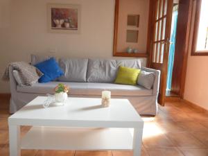 a living room with a couch and a white coffee table at Rincón de la Villa in Las Lagunas