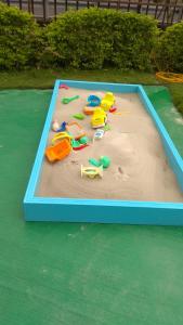a sandbox with toys in the sand on a playground at Dania Garden in Luodong