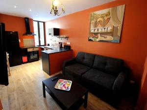 a living room with a couch and a table at Appartement Charlannes in La Bourboule