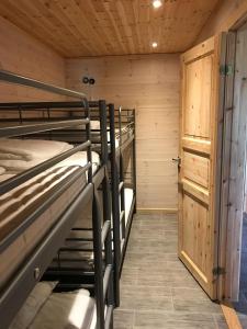 a room with two bunk beds in a cabin at Haga Park Camping & Stugor in Mörbylånga
