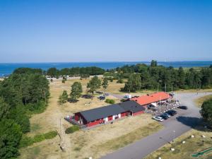an aerial view of a barn with a parking lot at Haga Park Camping & Stugor in Mörbylånga