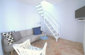a living room with a couch and a staircase at Casa Margarida Azul in Silves
