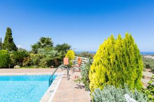 a villa with a pool and a view of the ocean at Villa Althaea in Loutra