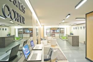 a lobby with two laptop computers on a table at Hotel 86 By Katipoğlu in İzmir