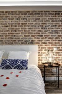 a bedroom with a brick wall and a bed at My Toul'House SPA in Toulouse