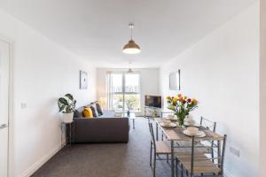 a living room with a couch and a table at 2-bedroom apartment Mill Court, Harlow in Harlow