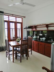 a kitchen with a wooden table and chairs and a dining room at Hikka Lagoon in Hikkaduwa +37 photos
