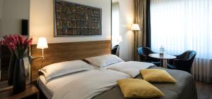 a hotel room with a large bed and a large window at Central Plaza in Zurich