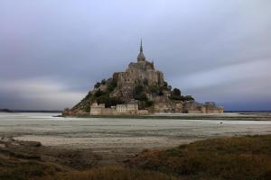 a large building with a clock on top of it at Le Saint Aubert in Le Mont Saint Michel