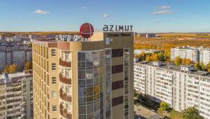 an apartment building with a sign on top of it at AZIMUT Hotel Penza in Penza