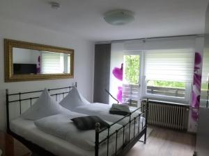 a bedroom with two beds and a window at Pension Pulvermühle in Waischenfeld +99 photos