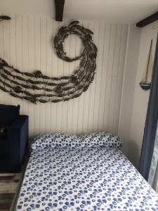 a bedroom with a bed with a wreath on the wall at Village Island Heights in Adeje