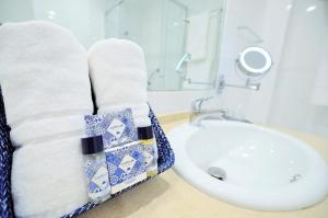 a bathroom with a sink and a towel rack next to a sink at HILLTOP OASIS Lisboa Oeiras in Oeiras