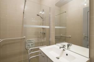 a bathroom with a sink and a shower at L'ecume by Cocoonr in Saint-Coulomb