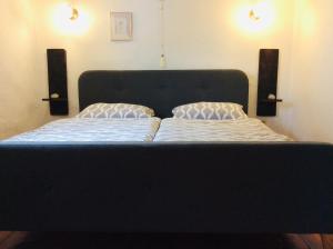 a bed with two pillows on it in a bedroom at Winzerhäuschen, Weingut Th. Müller in Reil