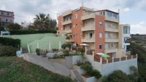 a large apartment building with stairs leading up to it at Eliza Apartments in Rethymno Town