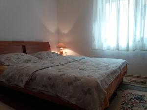 a bedroom with a bed and a window with curtains at Room at Grandma's Fatima in Stolac +30 photos