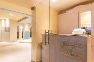 a kitchen with a counter with a glass door at Hotel La Gardenia & Villa Oleandra in Limone sul Garda