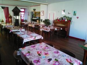 a dining room with tables with flowers on them at Le Relais De La Marche in Aigurande