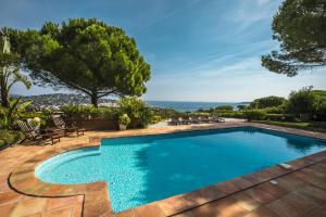 a swimming pool in the backyard of a house at Villa Zen Ste Maxime in Sainte-Maxime