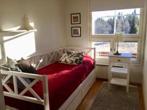 a small bedroom with a bed and a window at Herranterttu Apartments in Saariselka
