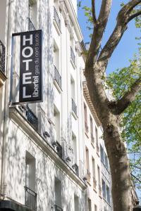 a sign on the side of a building with a tree at Libertel Gare Du Nord Suede in Paris