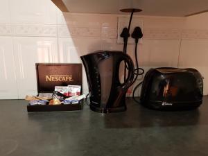 a coffee pot and a toaster sitting on a counter at Rainbow Guest House and Tours in Uitenhage