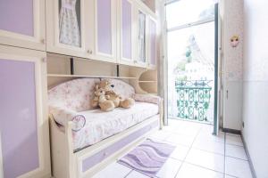 two teddy bears sitting on a bed in a room at La casa del capitano in Atrani