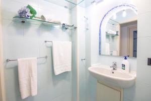 a white bathroom with a sink and a mirror at La casa del capitano in Atrani +18 photos