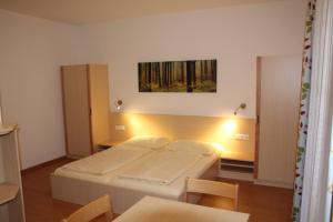 A bed or beds in a room at Jugendgästehaus St. Gilgen