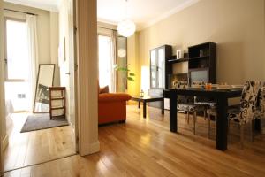 a living room with a table and a dining room at Casas FreshApartments in Málaga +21 photos